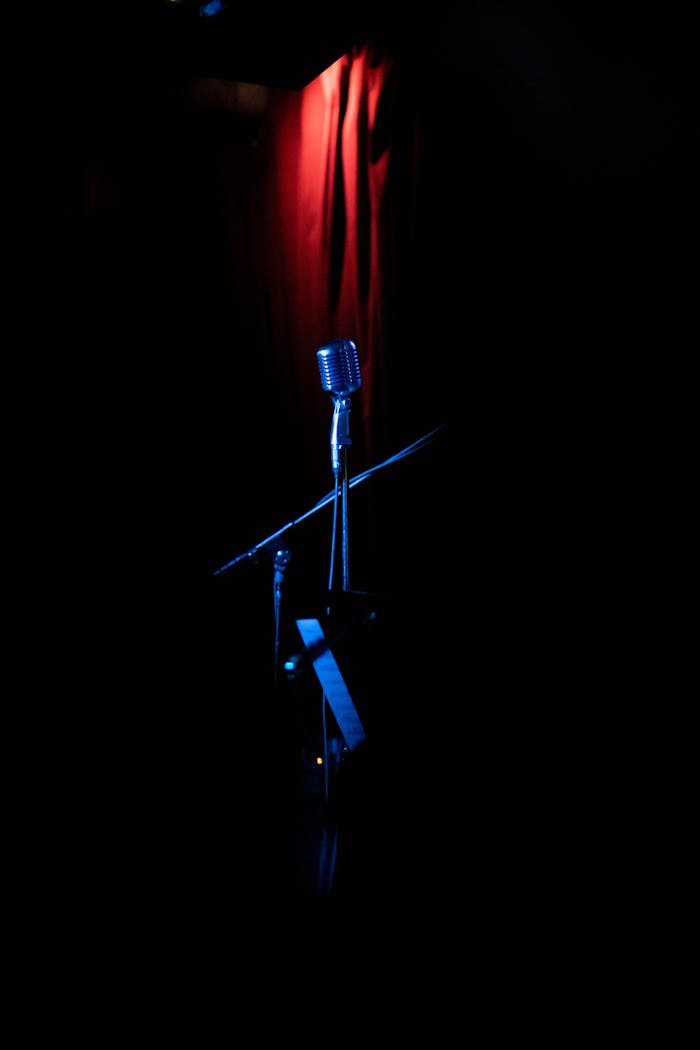 brand-03 A vintage microphone showcased on a dimly lit stage with dramatic lighting.