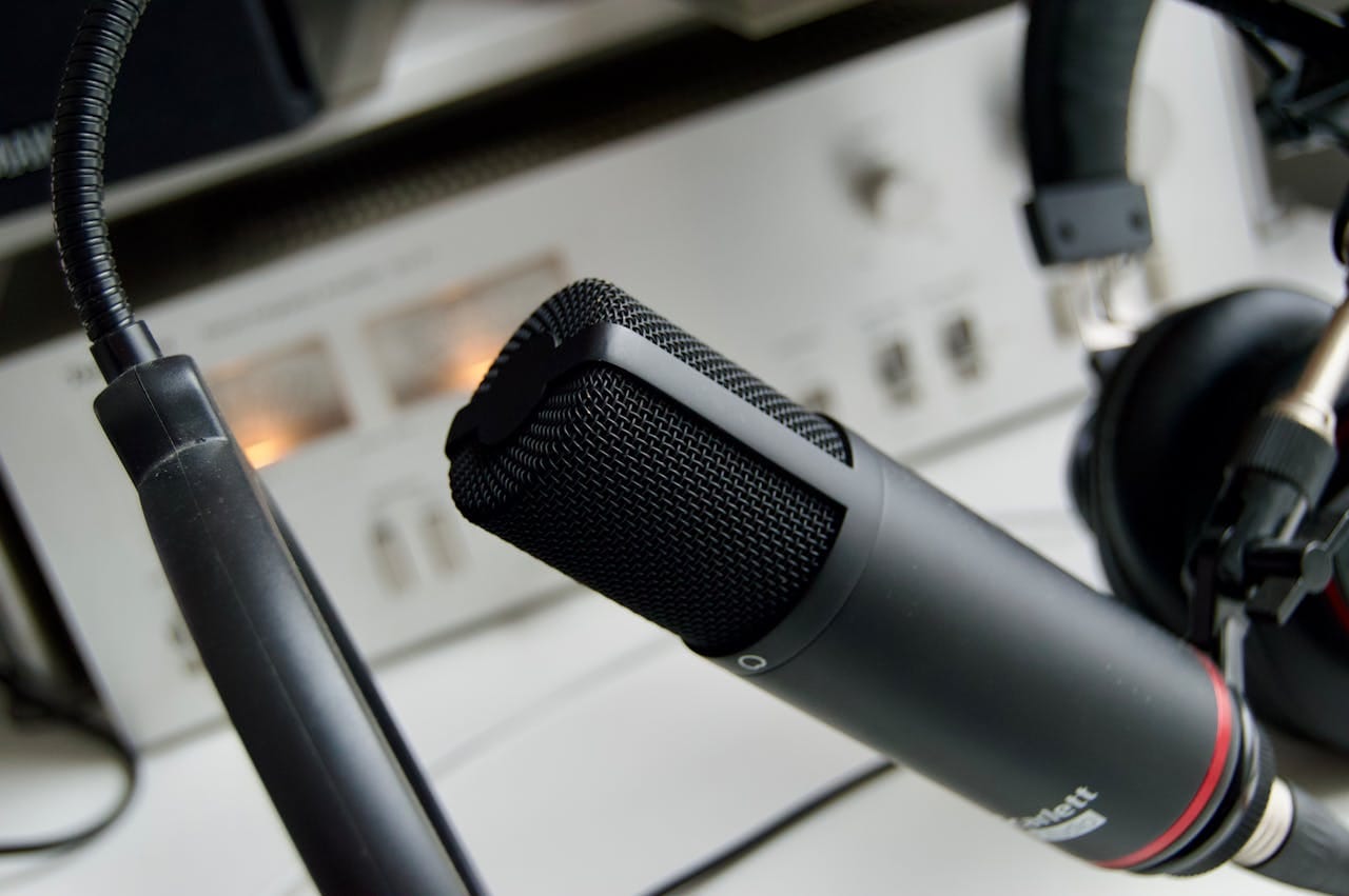 creative-02 Close-up shot of a microphone in a studio setting, ideal for audio recording.
